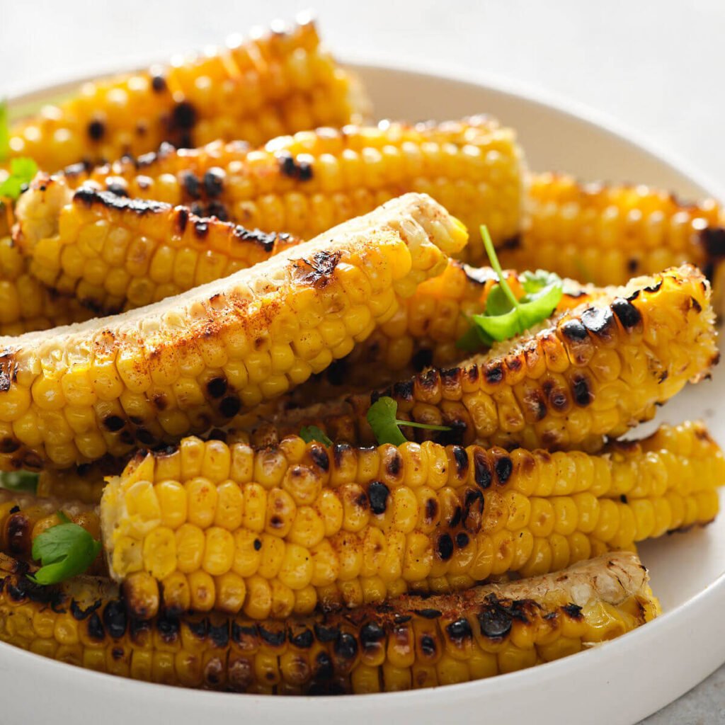 Miso butter corn ribs on a plate, golden and glossy, trending food USA 2026.