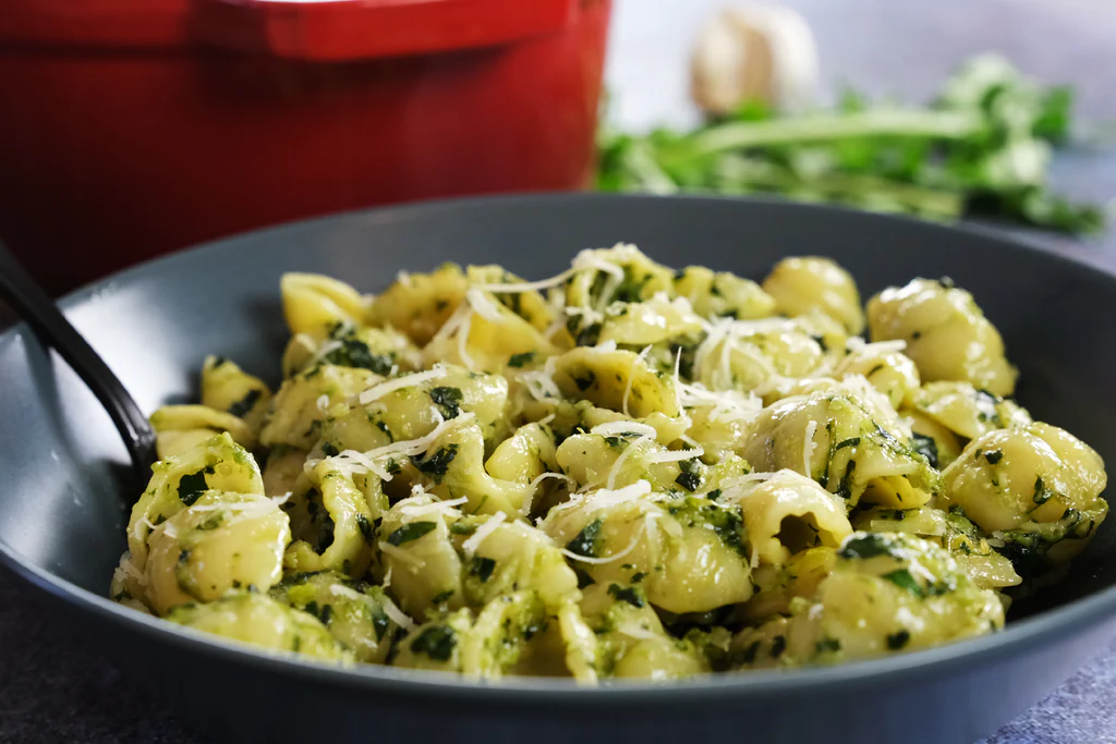 A fresh bowl of dandelion pesto pasta showcasing sustainable, plant-forward dining trends gaining popularity in the U.S. in 2026. 