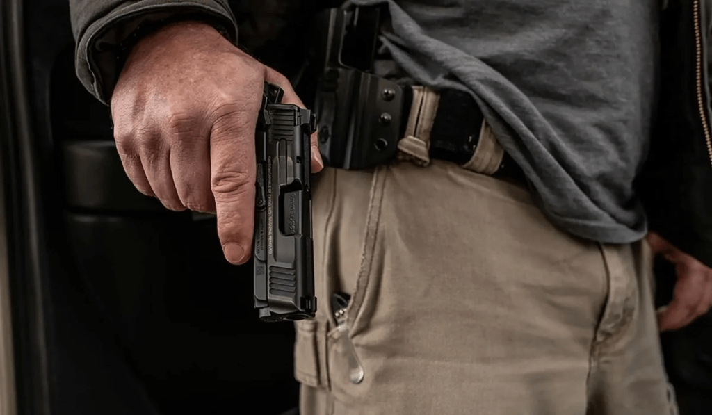 Concealed handgun in holster symbolizing public safety concerns